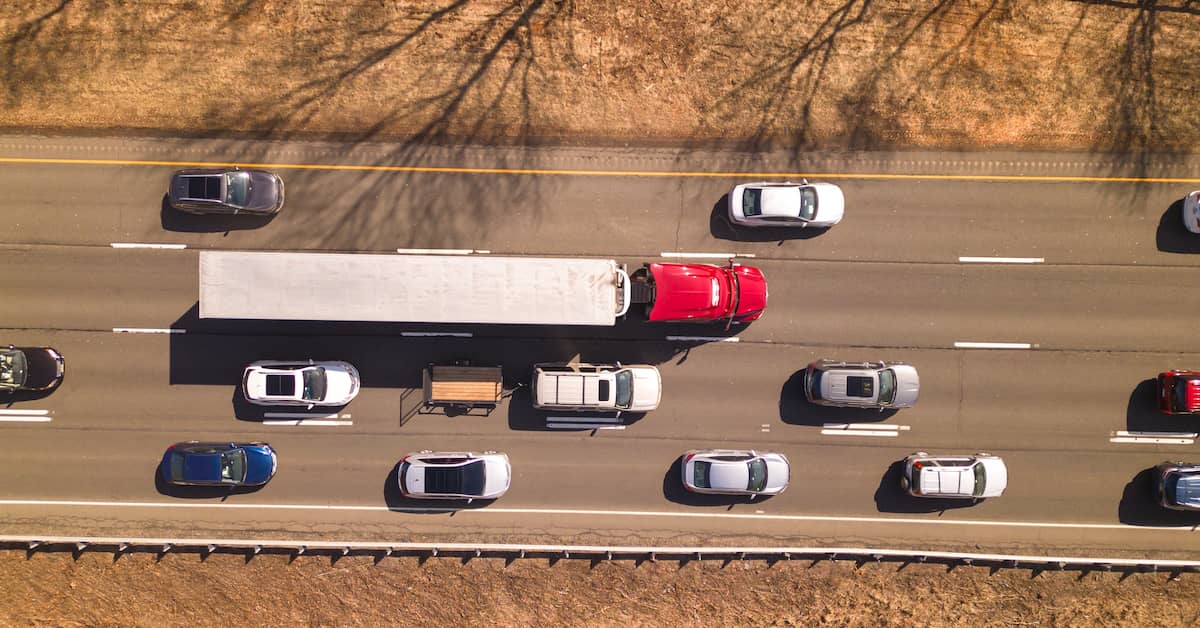 Bird's eye view of highway traffic with semi-truck and other vehicles | Colombo Law
