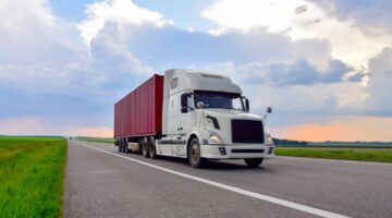 Commercial truck driving on a road | Colombo Law