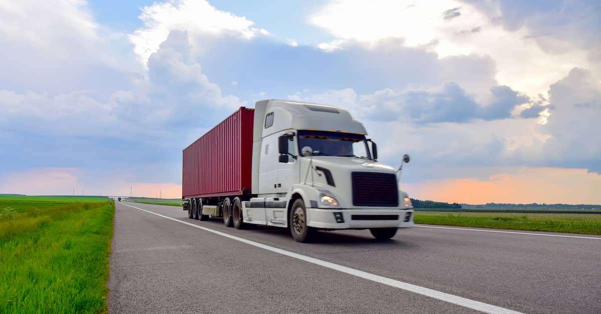 Commercial truck driving on a road | Colombo Law