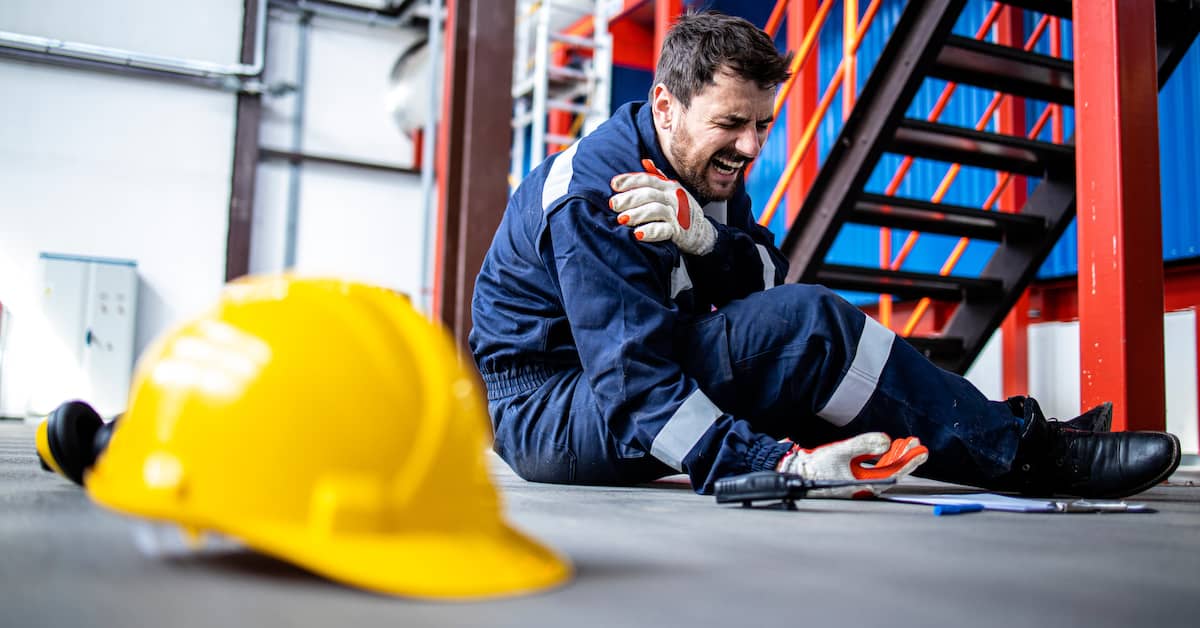 injured worker clutching shoulder after on-the-job accident