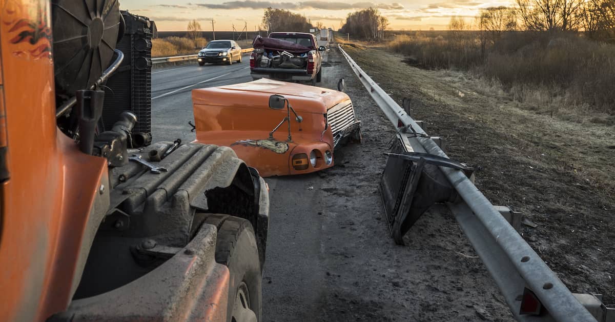 debris on the side of the road after a semi truck crash