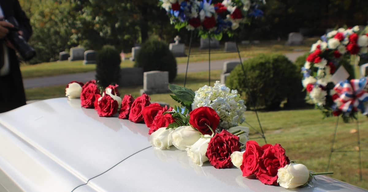 Flowers on the casket of a recently deceased person | Colombo Law
