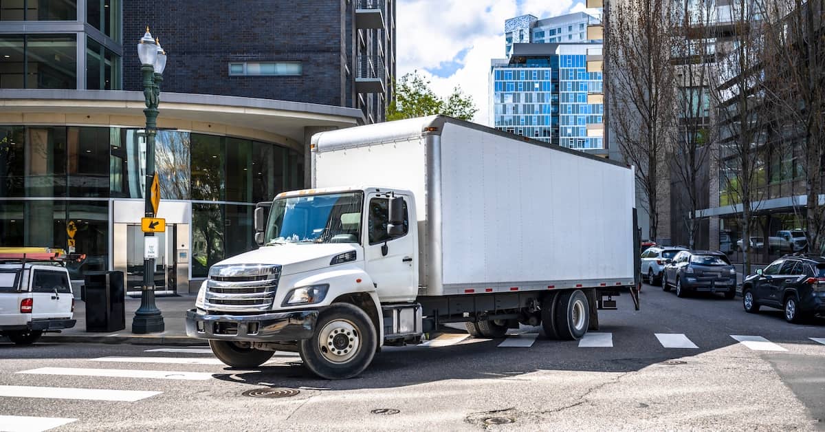 Commercial truck driving on a city street | Colombo Law