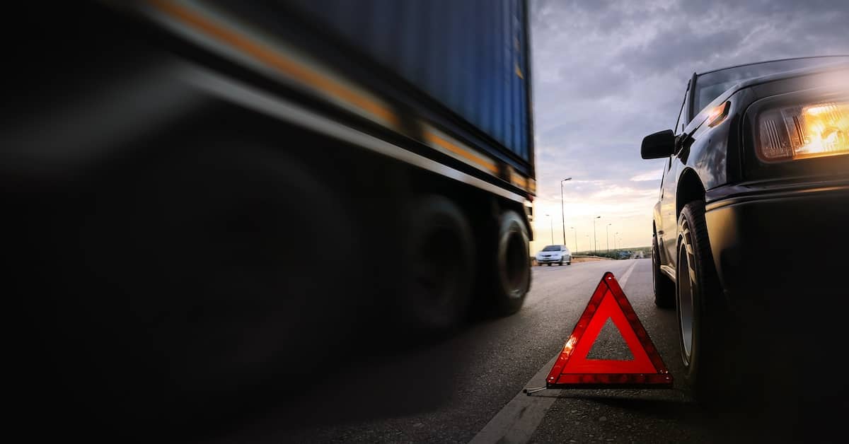 Caution triangle on the road after a truck accident | Colombo Law
