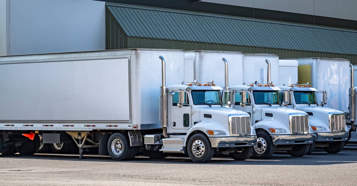 18-wheelers parked at a loading dock | Colombo Law