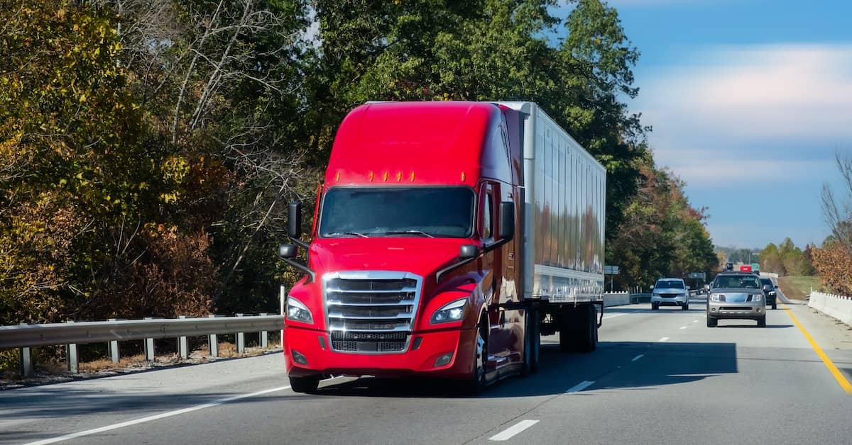 Semi-truck driving along a two-lane highway at the front of traffic | Colombo Law