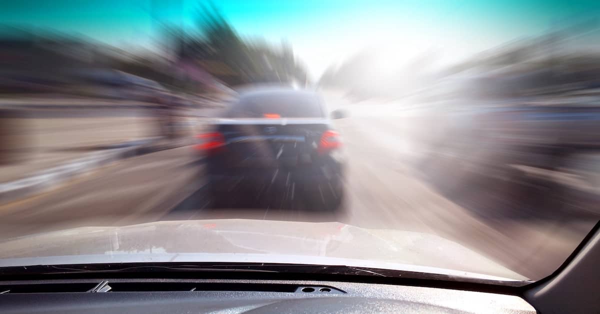 Speeding driver about to rear-end a car at an intersection | Colombo Law
