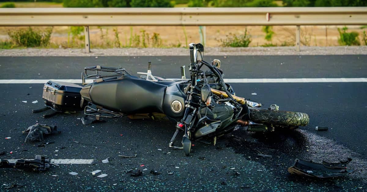 Damaged motorcycle lying on its side in the road after an accident | Colombo Law