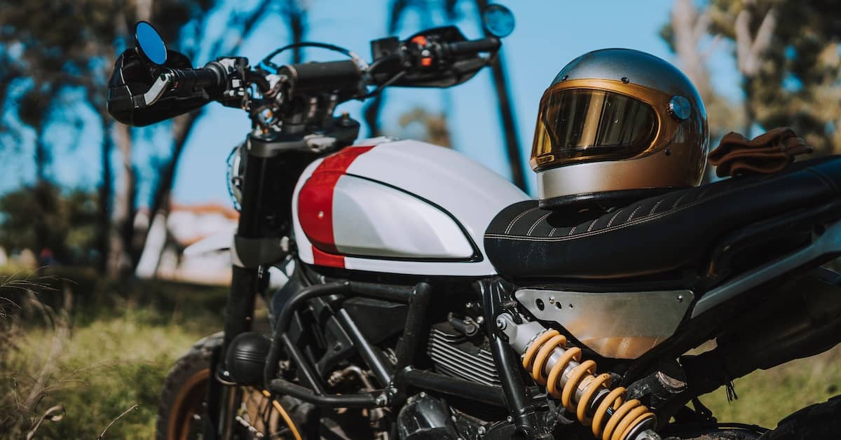 Motorcycle helmet resting on the seat of a motorcycle | Colombo Law