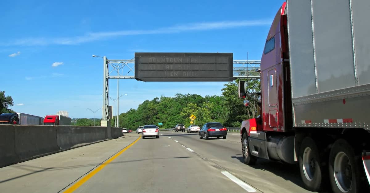 18-wheeler traveling down a 2-lane highway alongside other vehicles | Colombo Law